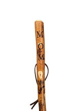 Walking stick with "MOM" carved down the handle and leather strap.