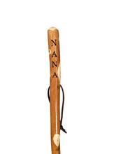 Walking stick with "NANA" carved down the handle and leather strap.