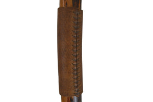 Close-up of a brown leather gun sleeve with stitching on a white background
