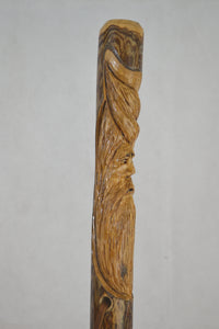 dark wood walking stick with face