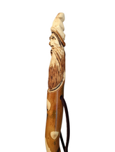 Walking stick with a carving of Gandalf at the top and the quote, "Home is now behind you. The world is ahead. -Gandalf" Stick facing the left. 