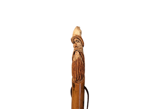 Walking stick with a carving of Gandalf at the top.