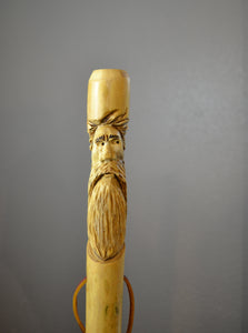 walking stick with face carving