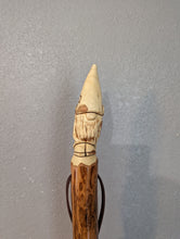 Gnome carved at the top of a walking stick. 