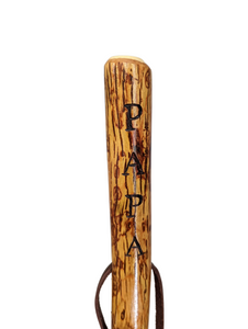 Walking stick with "PAPA" carved down the handle and leather strap. 