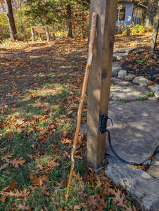 Sasquatch walking stick leaning on a post. 