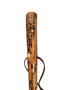 Hiking stick with "USA" carved at the top of the handle facing left. 