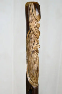 Carving of face on walking stick