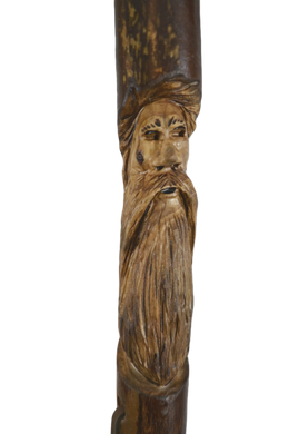 walking stick with face carvings