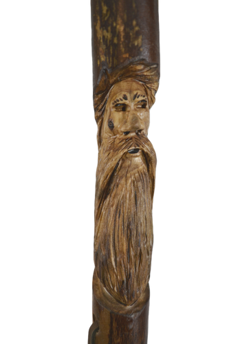 walking stick with face carvings