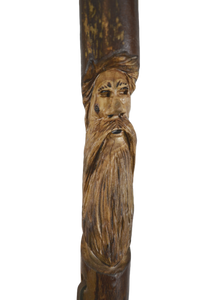 walking stick with face carvings