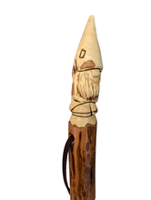 Gnome carved at the top of walking stick.