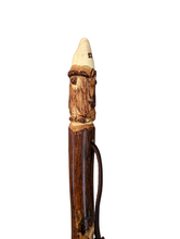 Walking stick with a Gnome carved at the top .