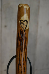 walking stick with heart carving and letters