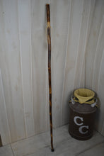 Cross carving on dark wood walking stick