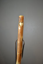 Walking stick with heart carving on it